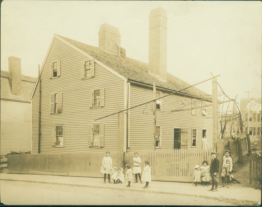 Sepia toned photograph iwth Itlian immigrant children in front of Gedney House