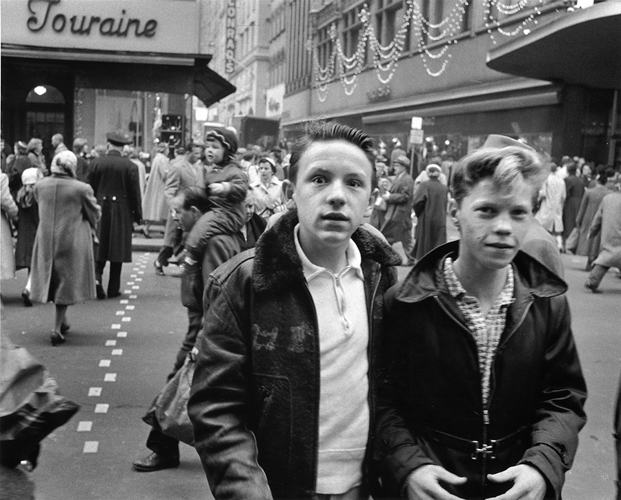 Two boys on street in downtown Boston. Black and white photo.