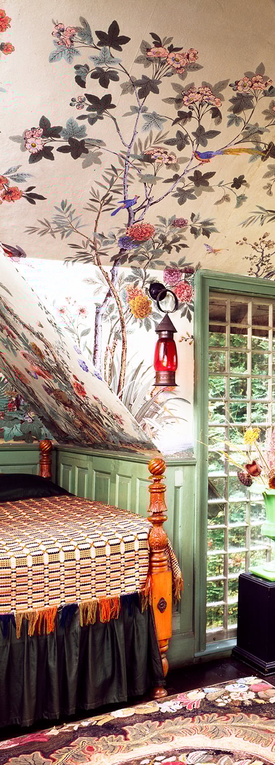 Colorful wallpapered alcove with plant and bird motif. Frame by green paianted window and paneling.